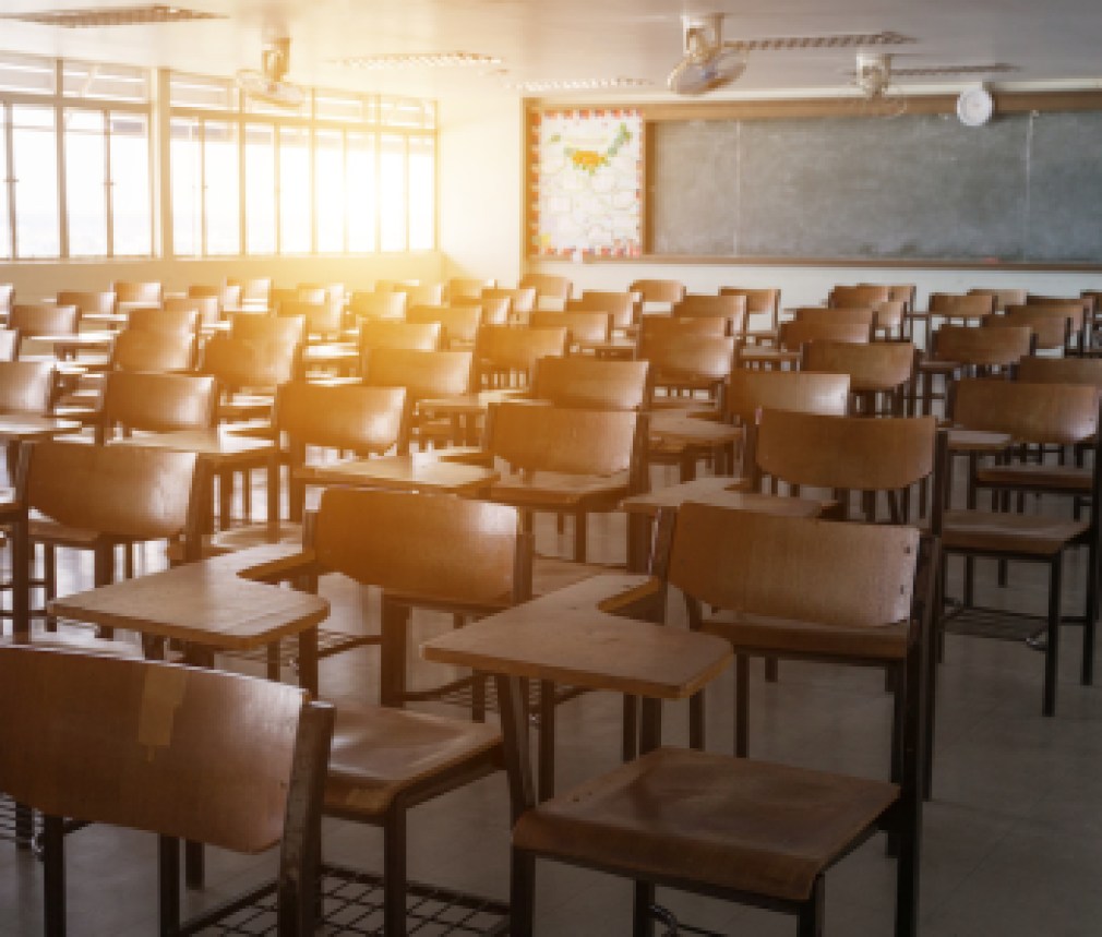 Empty classroom with vintage tone wooden chairs. Back to school concept.