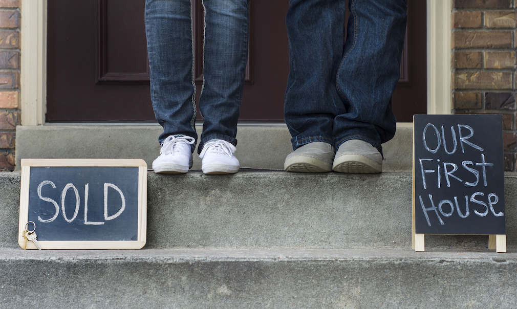 couple on doorstep of new home