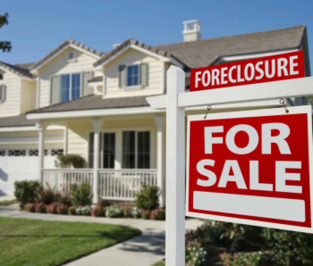Foreclosure Home For Sale Sign in Front of Beautiful House.