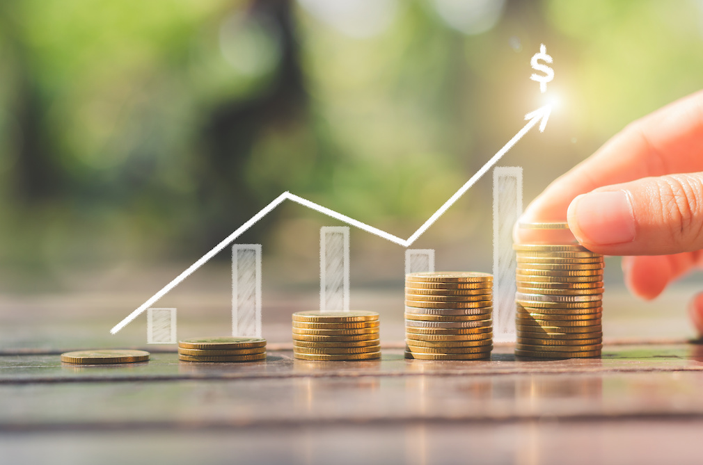 loan investment residential building house, real estate, property, mortgage concept. hand put coin stacking on wood table in green park background. startup graph growth up wealth.ESG.financial saving.