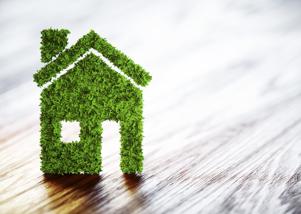 Ecology home concept. 3D illustration on wooden background.