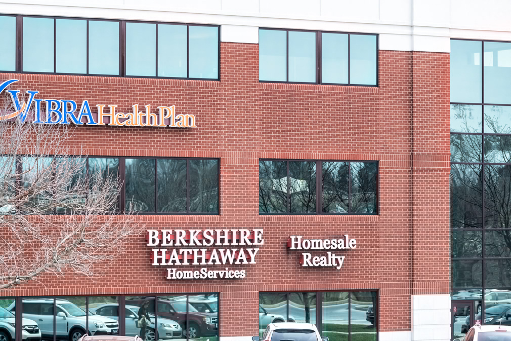 Harrisburg, USA - April 6, 2018: Berkshire Hathaway Home Services Homesale Realty and Vibra Health Plan store signs on building in Pennsylvania