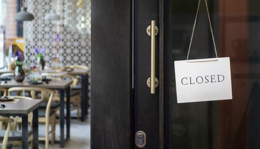 closed sign hanging outside a restaurant, store, office or other