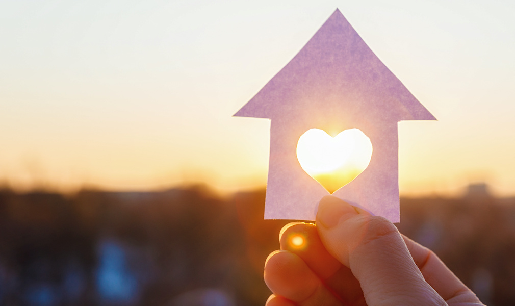 House with a carved heart on of sunrise.