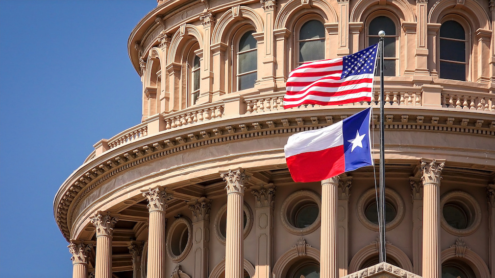 American and Texas Flags Flying at the Texas State Capitol Building in Austin