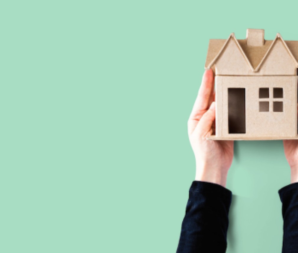 Woman holding a cardboard house