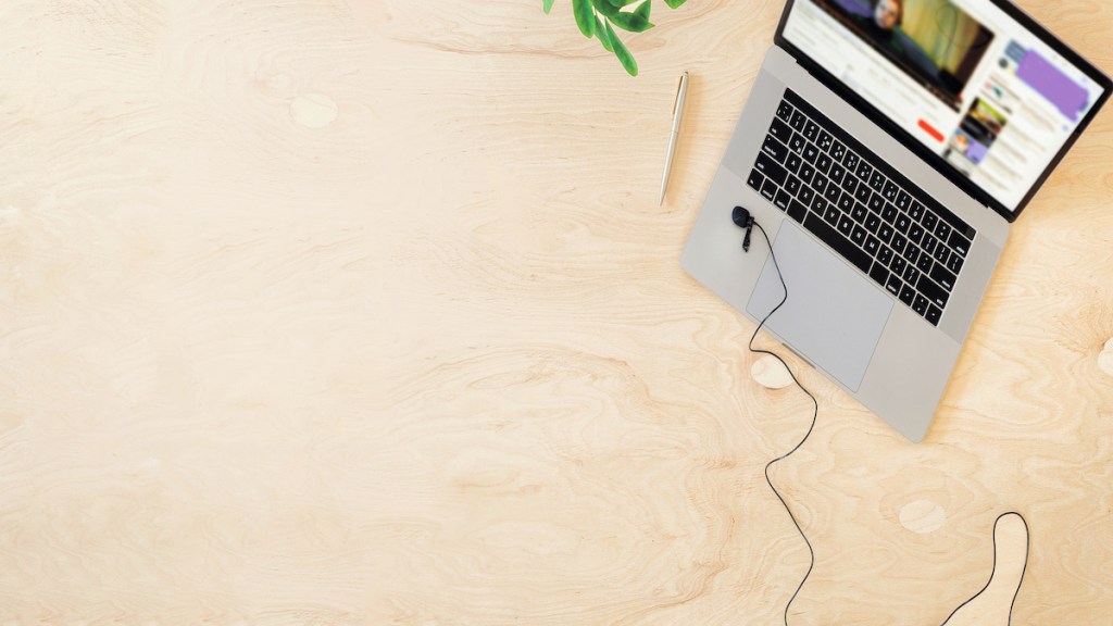 Online education or training concept top view. Laptop on the table with a live stream of teacher or coach. Copy space
