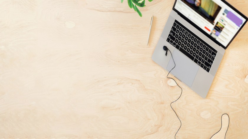 Online education or training concept top view. Laptop on the table with a live stream of teacher or coach. Copy space