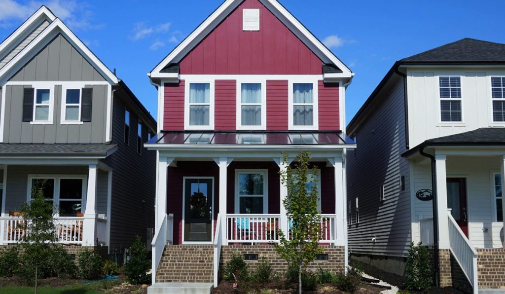 Two story, red, row house in a suburban neighborhood in North Carolina