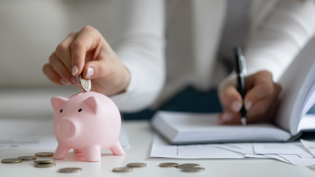 Close up of woman saving money managing home finances