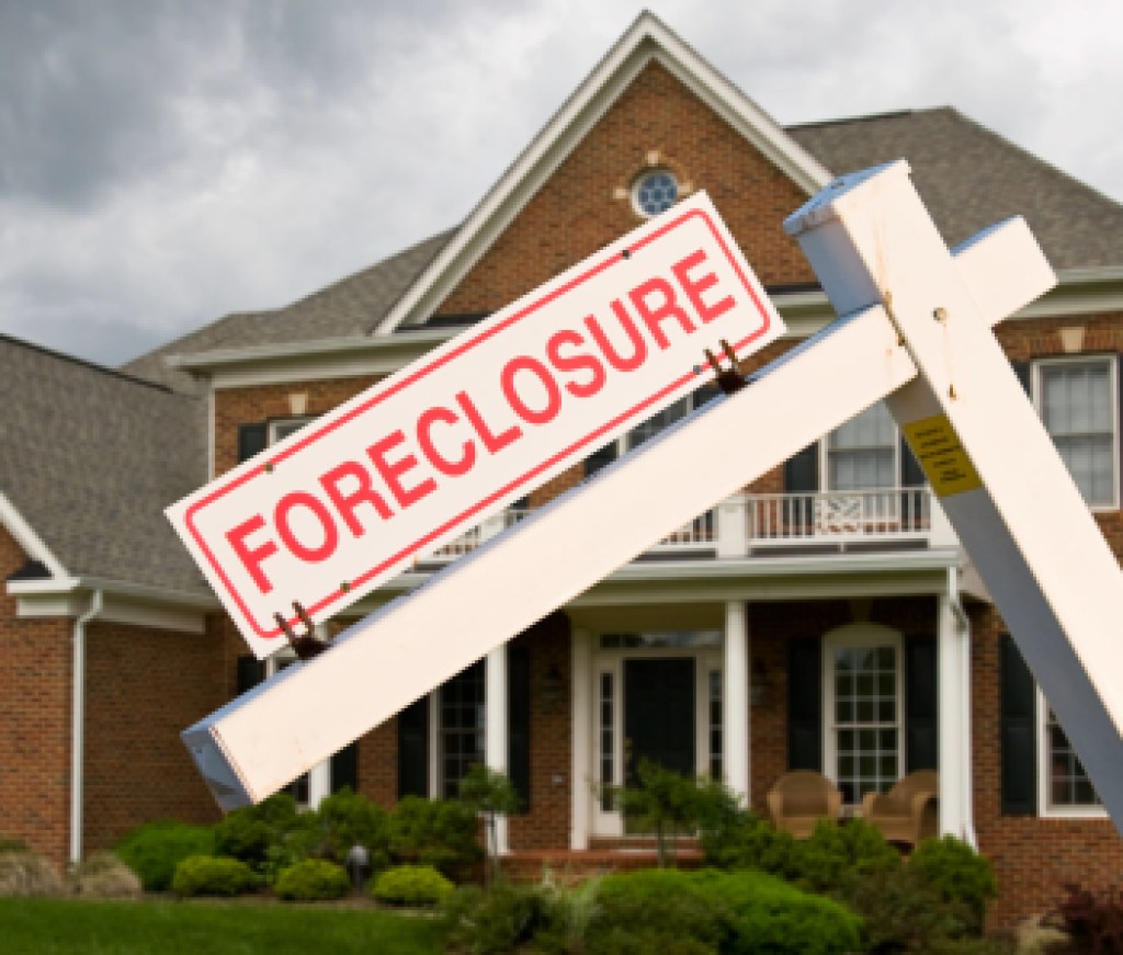 Foreclosure sign in front on modern house