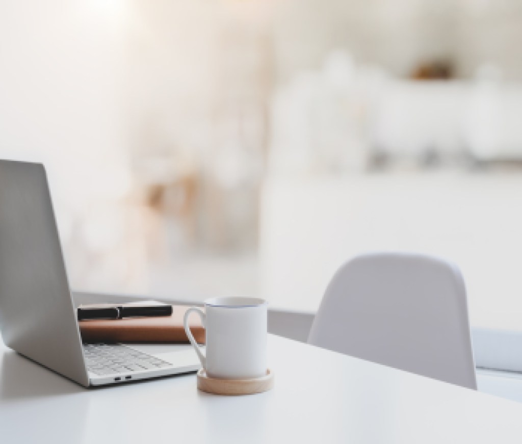 Modern workplace with laptop computer, coffee cup and office supplies