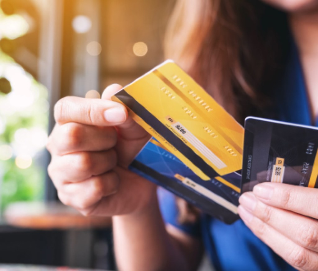 Closeup image of a woman holding and choosing credit card to use