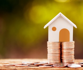 Loan or saving money for buy a house and real estate for family concept, Home model put on the stack coin tower with growing business investment in the in the public park.