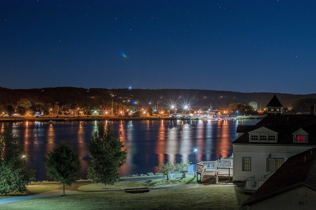 Beautiful shot of buildings with lit lights in the distance at night time in Michigan