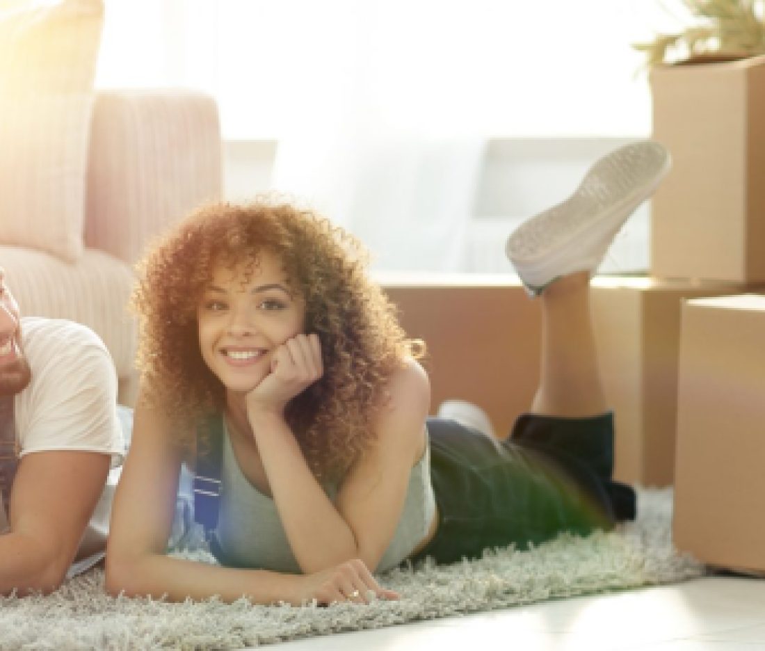 concept of moving to a new home. Happy couple lying on the floor