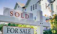 for sale sign showing that a home has been sold