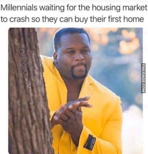 Picture of man in yellow jacket peeking out behind a tree.