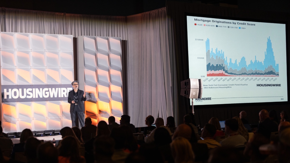 Logan Mohtashami presenting on stage at a HousingWire event